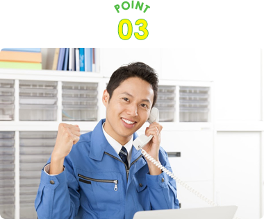 ガッツポーズをとる作業服の男性